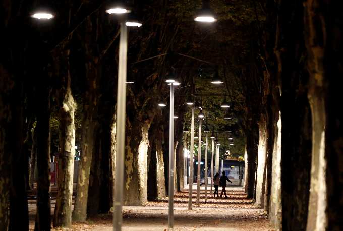 People walk down an avenue in the center of Bordeaux, France.